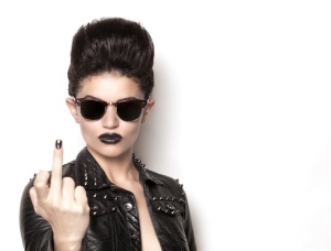 Beautiful rocker girl wearing a leather jacket and sunglasses